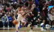 Philadelphia 76ers guard Kelly Oubre Jr dribbles up the court while Miami Heat forward Jimmy Butler defends