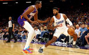 LA Clippers forward Paul George handles the ball against Phoenix Suns forward Kevin Durant