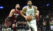 Boston Celtics forward Jayson Tatum (0) drives to the basket past Miami Heat forward Caleb Martin