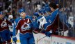 Colorado Avalanche center Nathan MacKinnon celebrates with the bench after his goal in the third period against the Winnipeg Jets