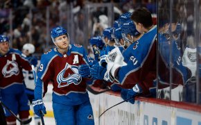 Colorado Avalanche center Nathan MacKinnon celebrates with the bench after his goal in the third period against the Winnipeg Jets