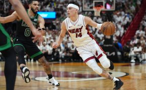 Miami Heat guard Tyler Herro dribbles around Boston Celtics forward Jayson Tatum