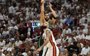 Boston Celtics forward Jayson Tatum shoots a three over Miami Heat forward Caleb Martin