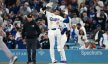 Los Angeles Dodgers designated hitter Shohei Ohtani reacts after hitting an RBI single during the tenth inning against the Atlanta Braves