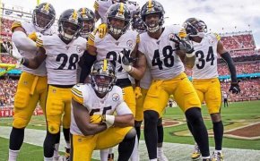 Steelers defense posing for a group photo after a return touchdown