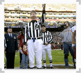 photo of a referee tossing a coin at a football game featuring cleveland and washington