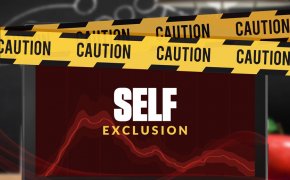 self exclusion text overlay on laptop with caution tape