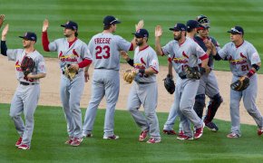 St Louis Cardinals players celebrating on the mound after a win.